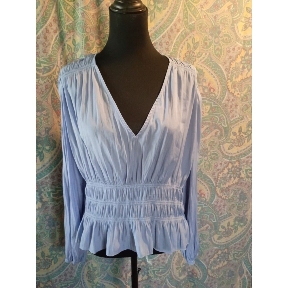 light blue V-neck blouse from Universal Thread features a smocked waist and...